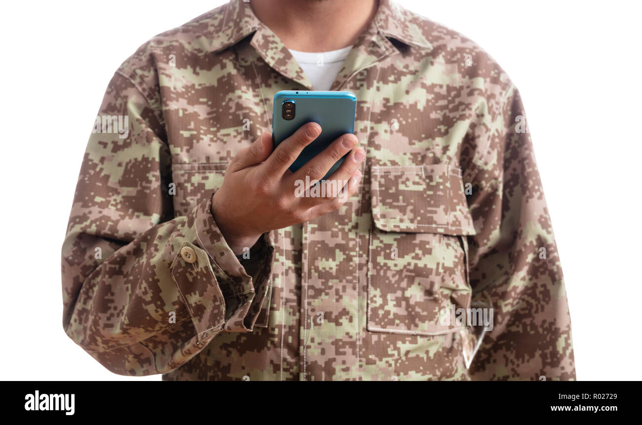 US Army. Young soldier holding a mobile phone standing on white background Stock Photo