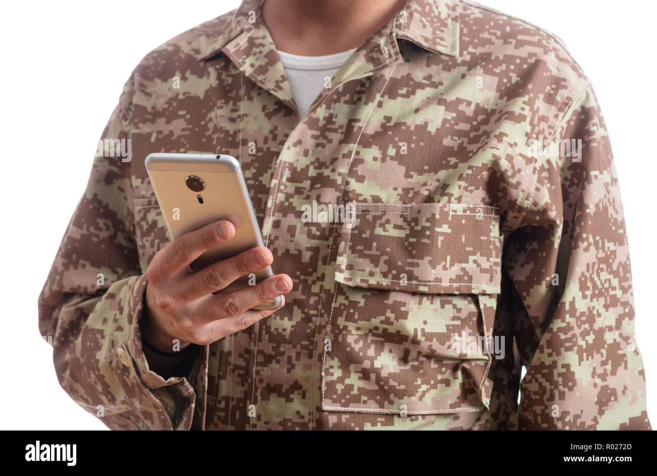 US Army. Young soldier holding a mobile phone standing on white background Stock Photo