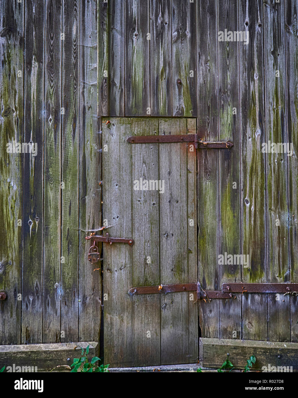 Old Weathered Wooden Barn Door With Steel Hinges Stock Photo