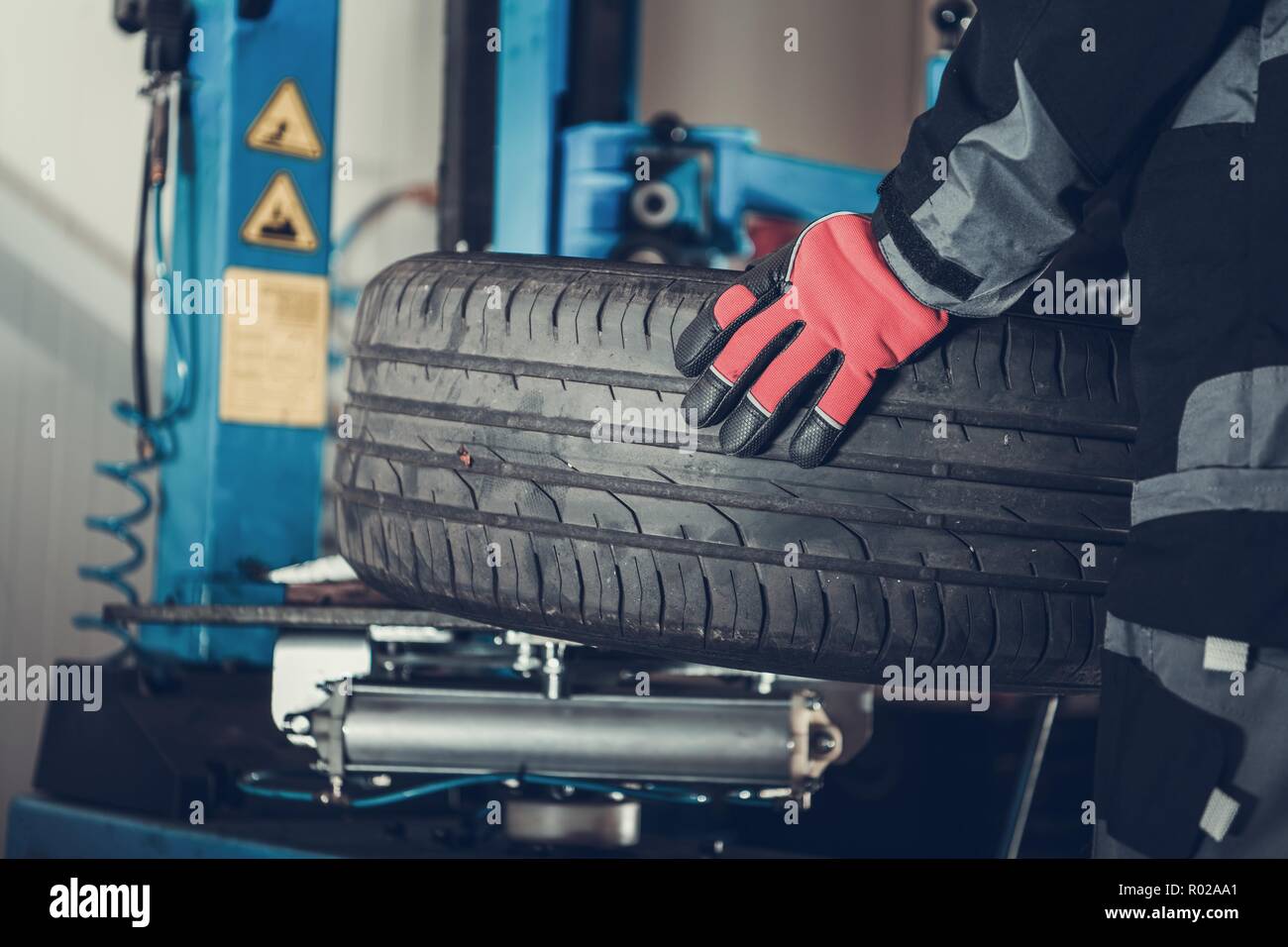 Seasonal Car Tires Change. Vulcanizer at Work. Auto Service Stock Photo