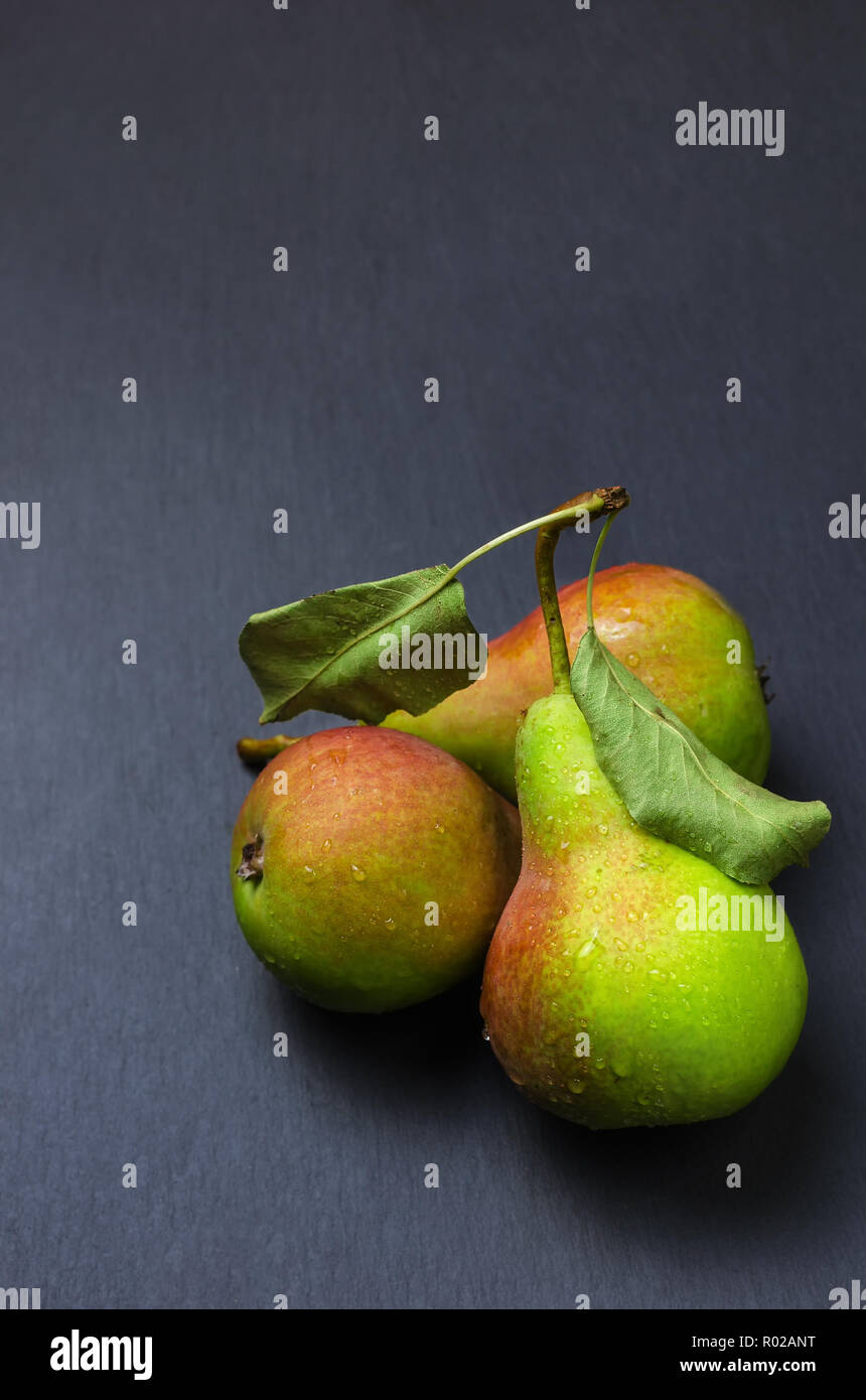 Fresh ripe pears on black shale stand, closeup Stock Photo - Alamy