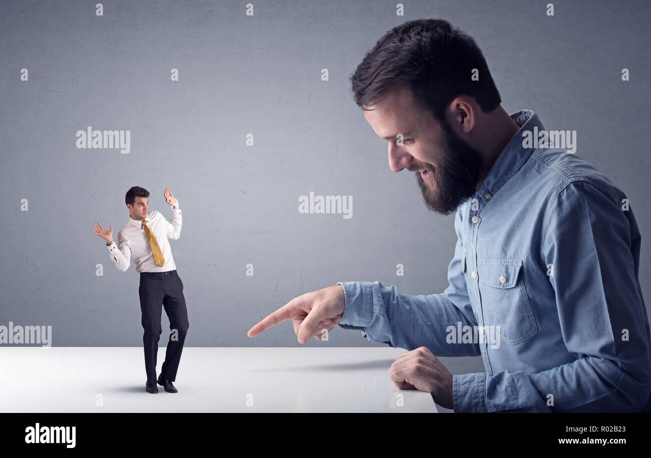 Young professional businessman being angry with an other miniature ...