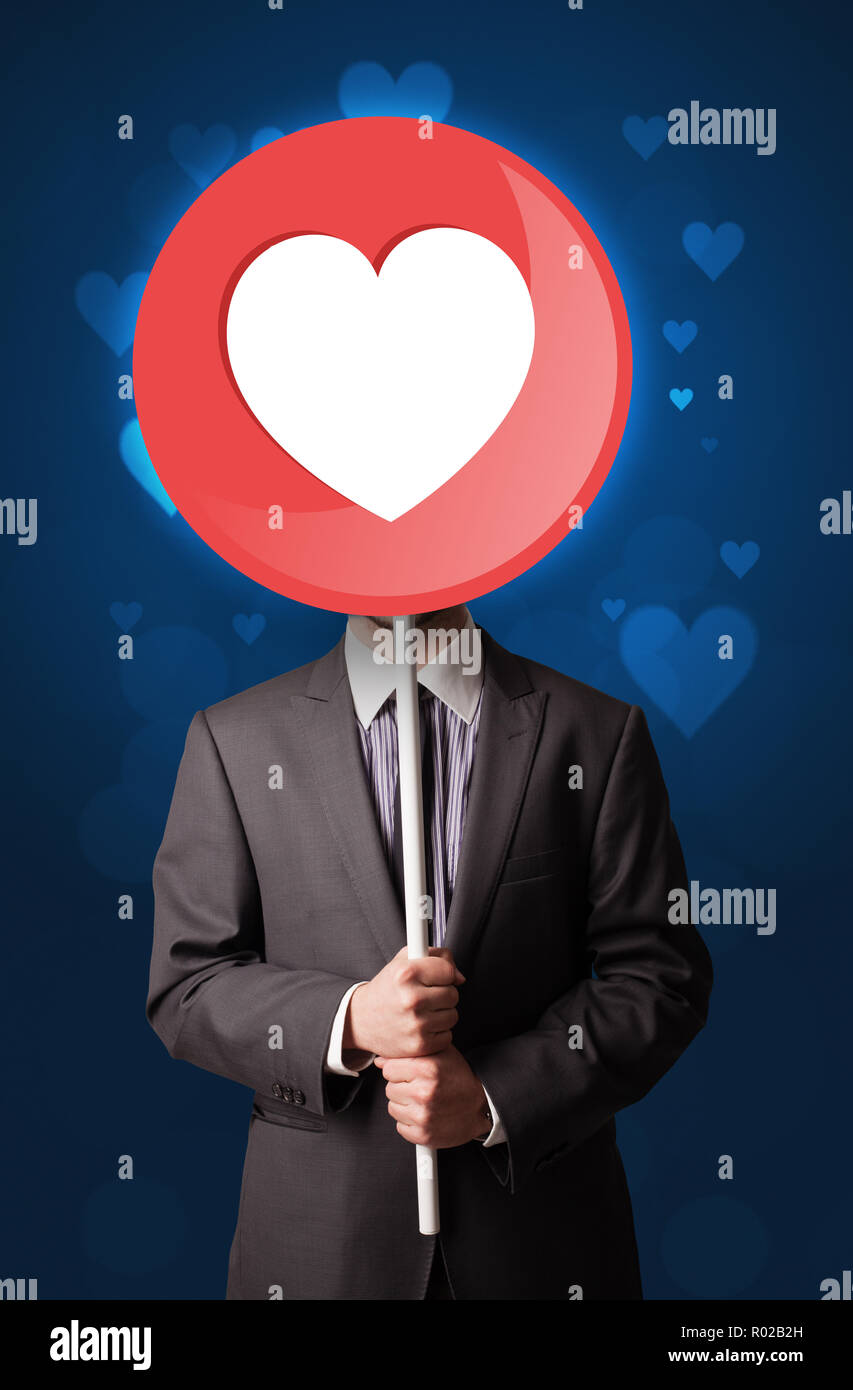Smart businessman holding round sign with heart Stock Photo Alamy