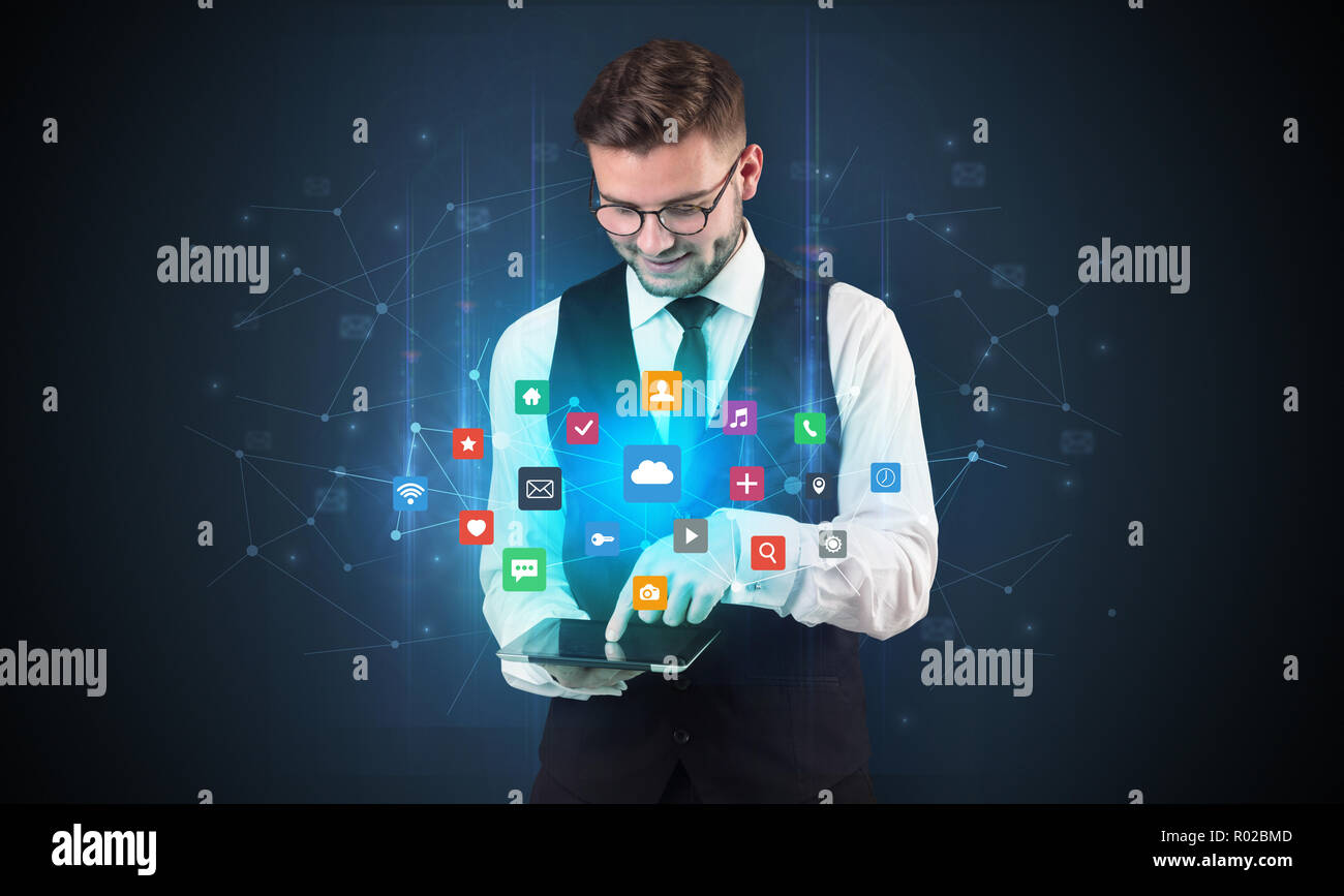 Handsome businessman in suit with tablet on his hand and application ...