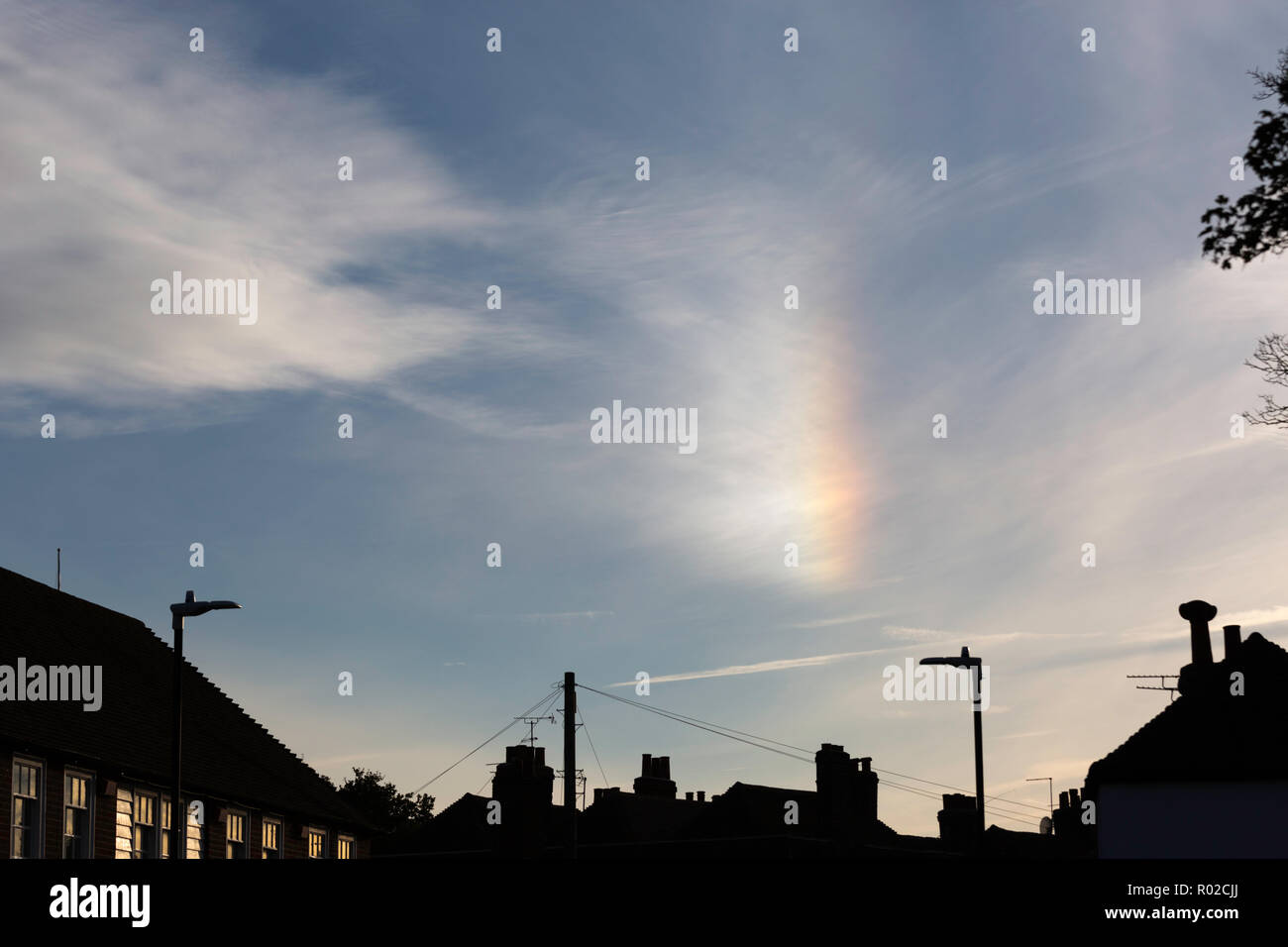 Sun dog (parhelion) seen above the rooftops during the afternoon in Canterbury, Kent, UK. Stock Photo