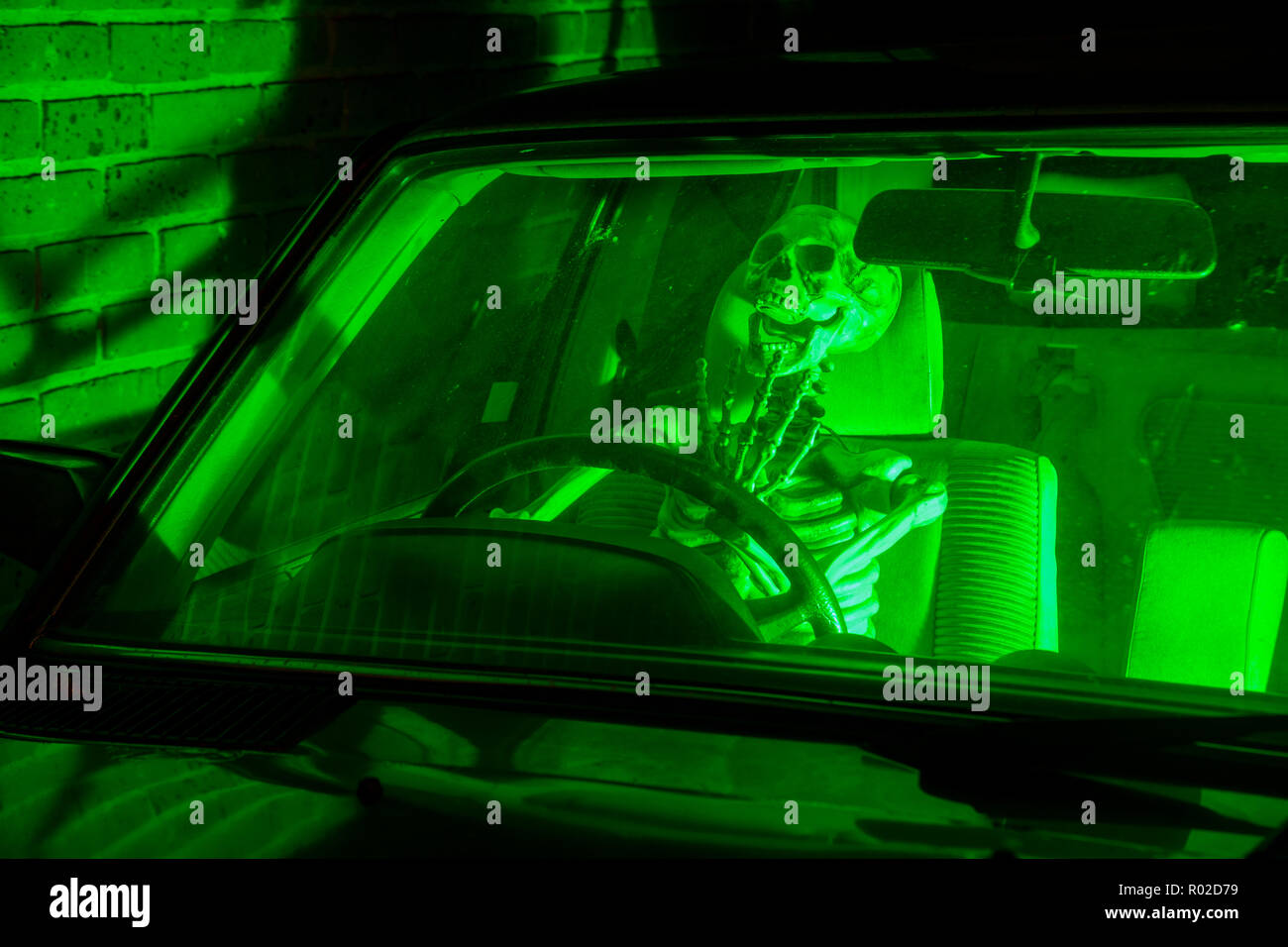 Skeleton screaming in the drivers seat of a car Stock Photo