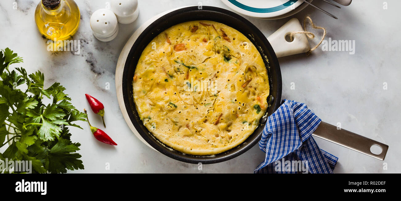 banner of vegan frittata without eggs in a pan on the table. healthy italian appetizer for the whole family or party Stock Photo