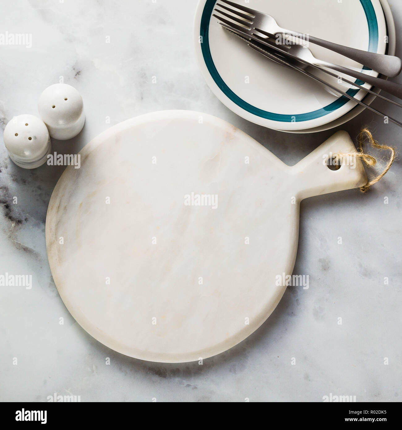 empty marble cutting board on a marble table. copy space Stock Photo