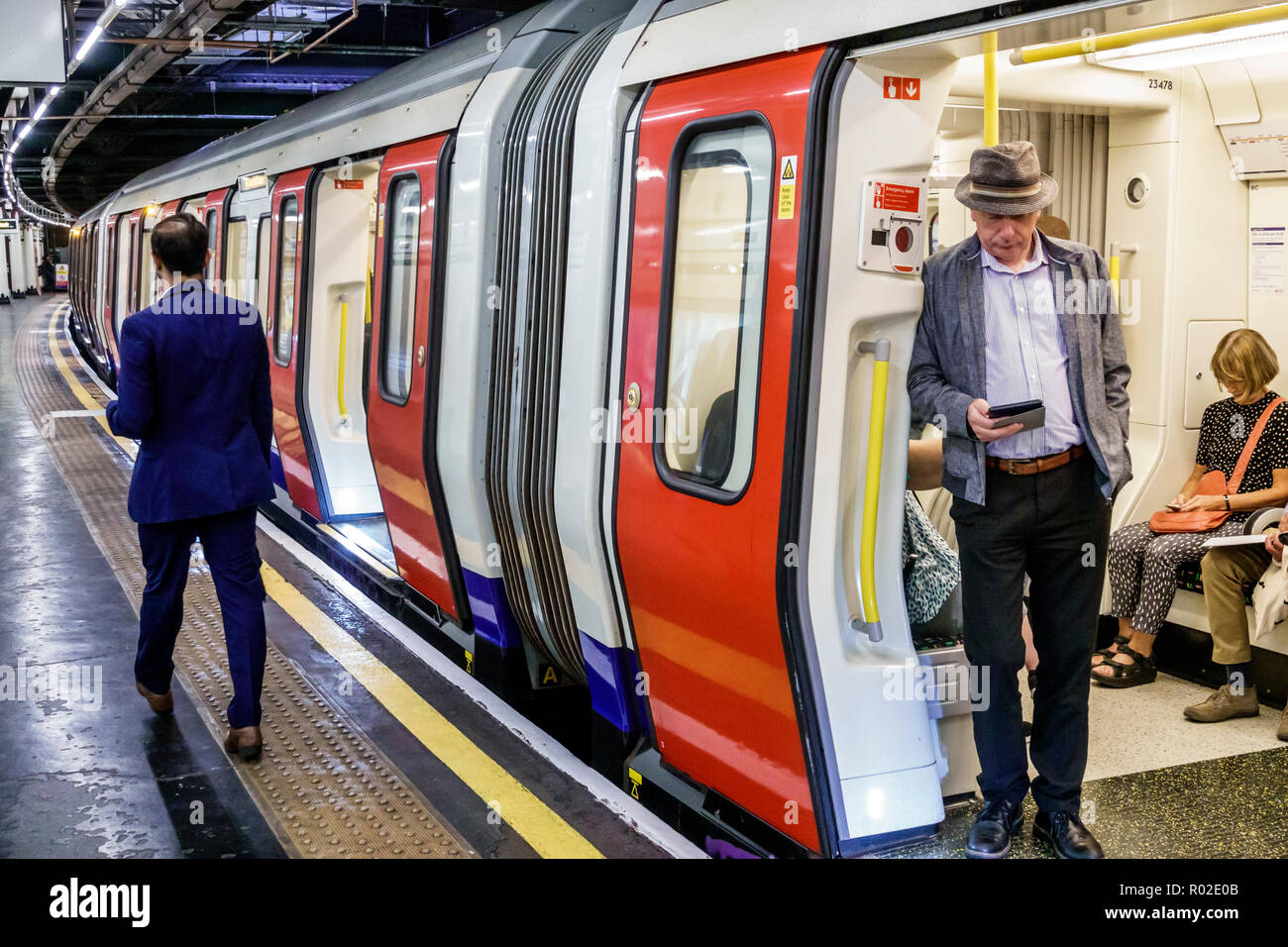 London England,UK,Embankment Underground Station train Tube,subway tube,platform,man men male,passenger passengers rider riders,commuter,train,stopped Stock Photo