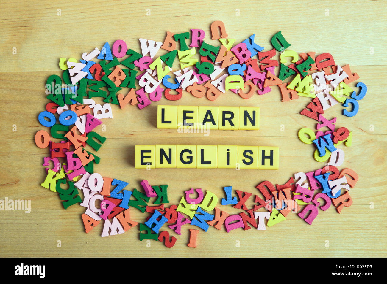 Learn English message near a pile of other letters over wood board background Stock Photo