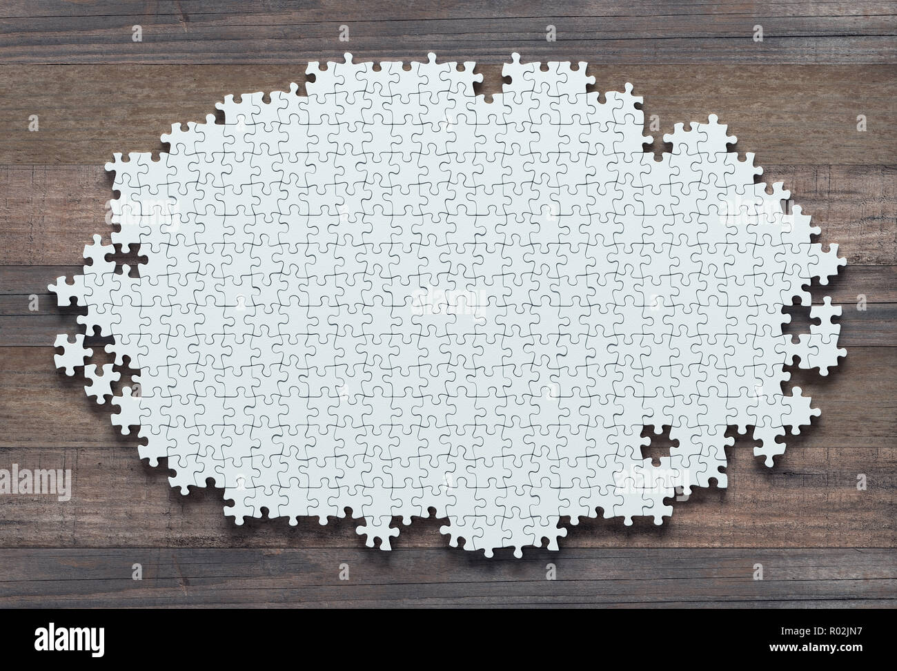 Blank jigsaw puzzle missing pieces to finish. Concept of work not completed. Stock Photo