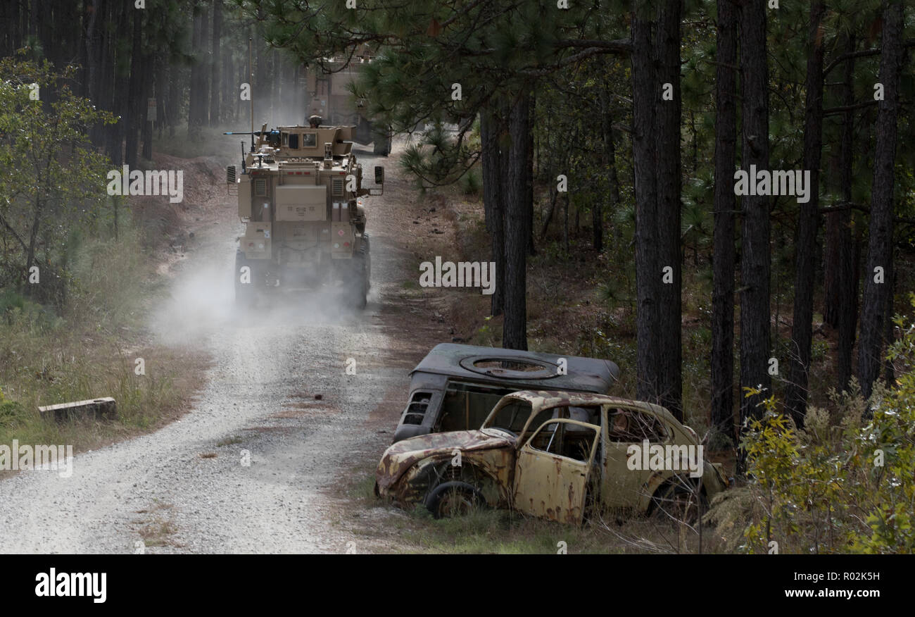 U.S. Soldiers from 2nd Battalion, 2nd Security Force Assistance Brigade, convoy to a village in their Mine-Resistant Ambush Protected vehicles while engaging targets as part of a live-fire exercise at Fort Bragg, North Carolina, Oct. 24, 2018. The 2nd SFAB is conducting training as they prepare to deploy to Afghanistan in the spring of 2019 to provide training and advising assistance to Afghan National Security Forces. (U.S. Army photo by Spc. Andrew McNeil / 22nd Mobile Public Affairs Detachment) Stock Photo