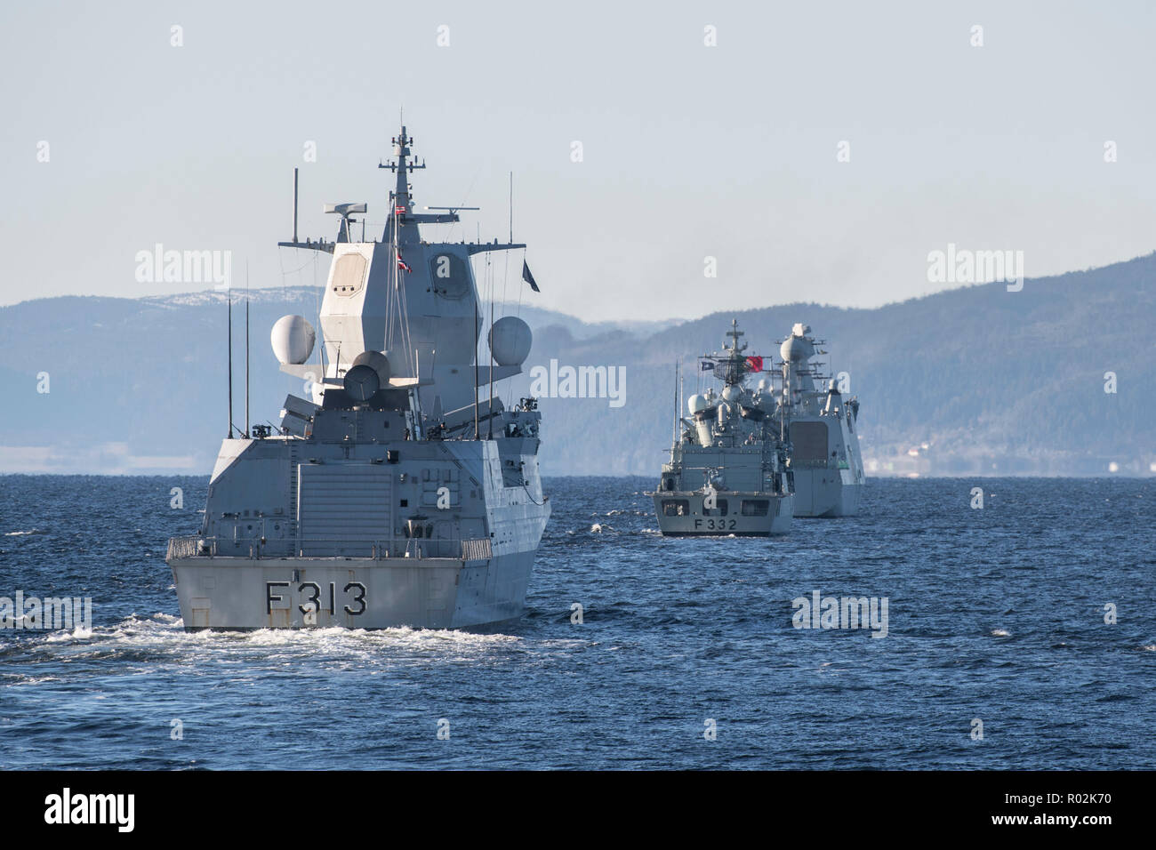 Her Majesty’s Canadian Ship (HMCS) VILLE DE QUÉBEC follows His Norwegian Majesty’s Ship HELGE INGSTAD, Portuguese Naval Ship CORTE-REAL, and Her Danish Majesty’s Ship ESBERN SNARE into The Trondheim Fjord during Exercise TRIDENT JUNCTURE on October 29, 2018.    Photo: MCpl Andre Maillet, MARPAC Imaging Services Stock Photo