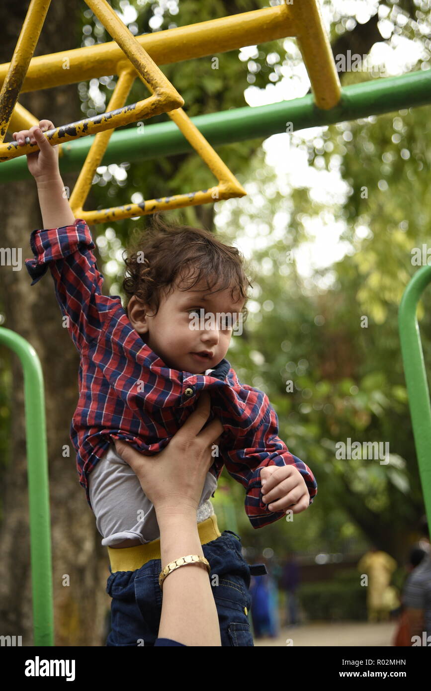 cute smiling kids enjoying play time with playful mood in amusement park or children park in New Delhi, India, Asia Stock Photo