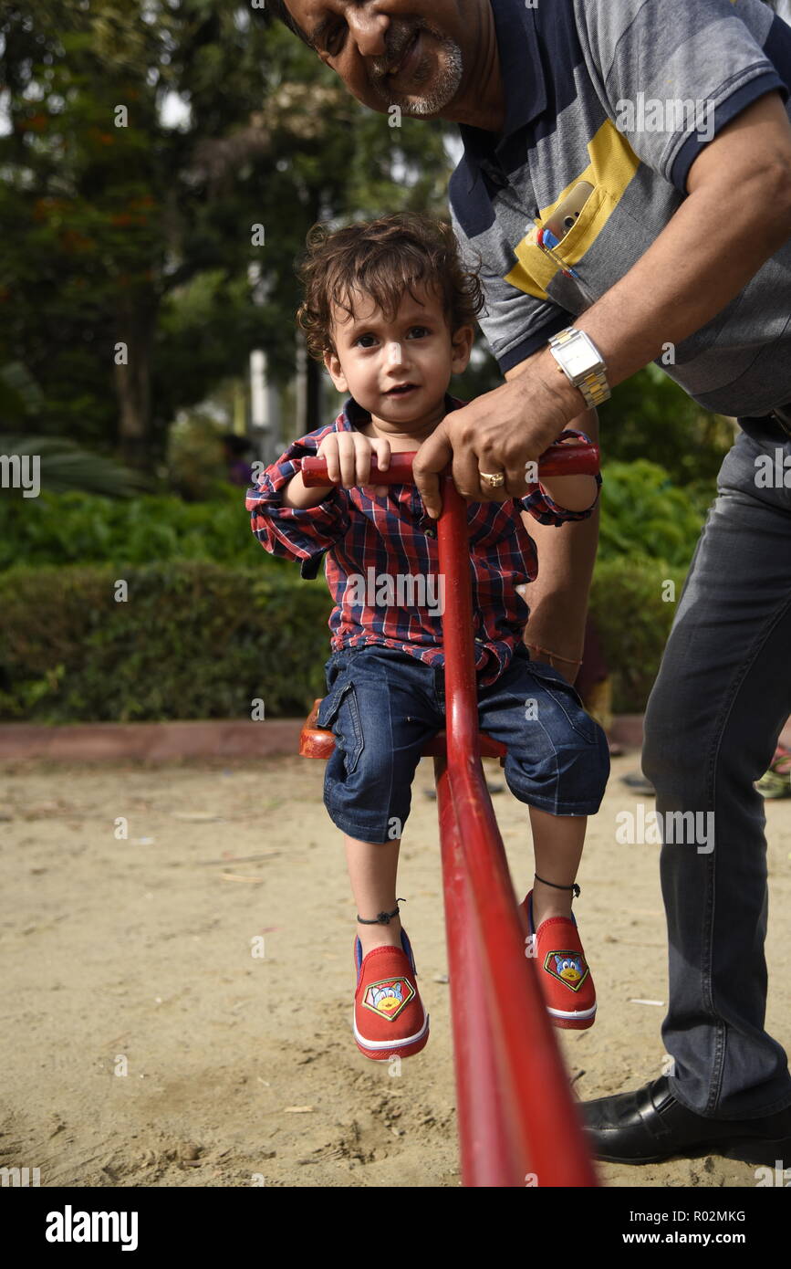 cute smiling kids enjoying play time with playful mood in amusement park or children park in New Delhi, India, Asia Stock Photo