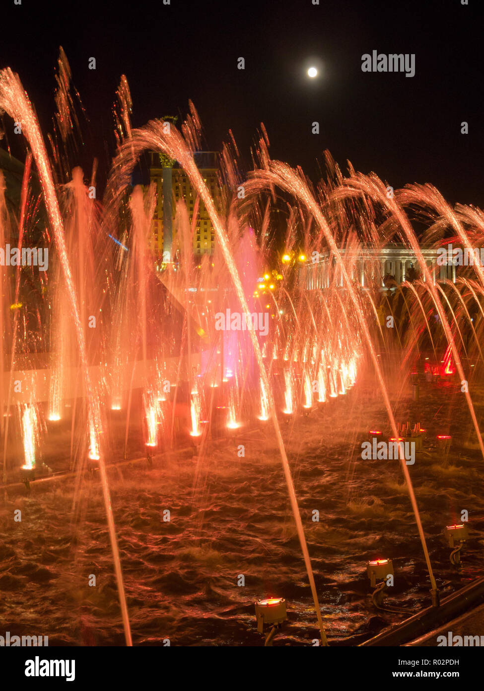 Colored water jets in the fountain at night Stock Photo - Alamy