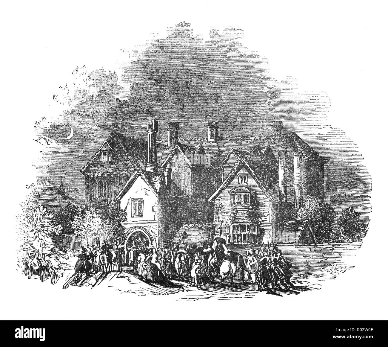 Guests arriving at a country masion, along with the Yule log, Yule clog, or Christmas block, specially selected log burnt on a hearth as a Medieval Christmas tradition. The origin of the folk custom is unclear but the custom may ultimately derive from Germanic paganism. The Yule log is dragged into the Manor House by servants and put on the hearth. Once lit and in place the locals sit around the Yule log, drink, eat and dance and tell ghost stories, England Stock Photo
