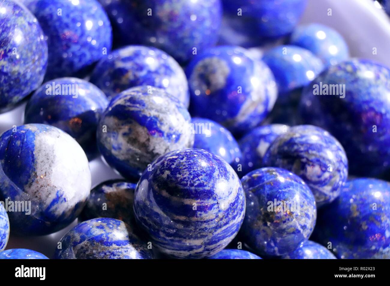 Cobalt blue lapis lazuli balls with white veins. Stock Photo