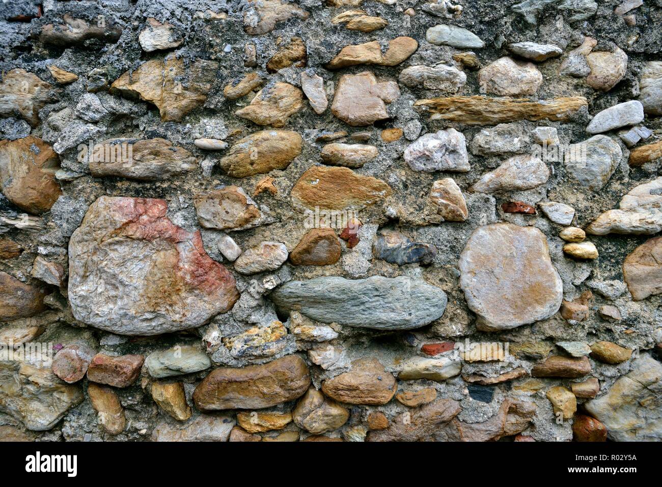 Weathered old stone wall background Stock Photo
