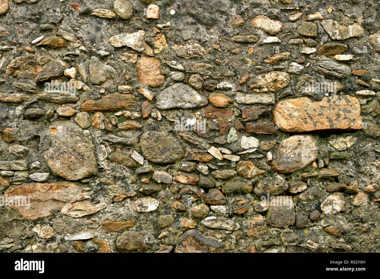 Weathered old stone wall background ocher tone Stock Photo