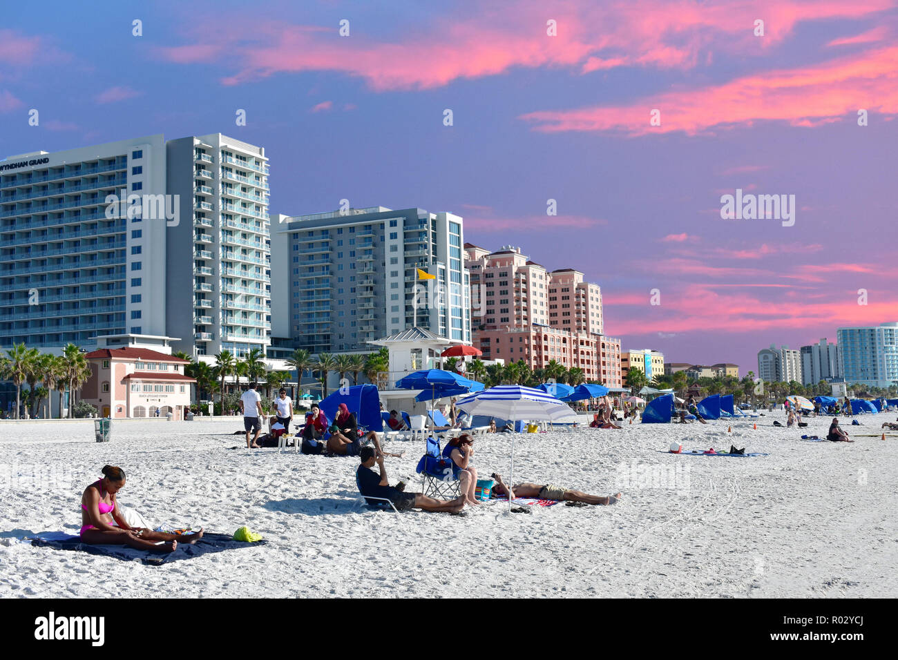 Clearwater Beach, Florida. October 18, 2018 People relaxing at the beach on colorful sunset background. Stock Photo