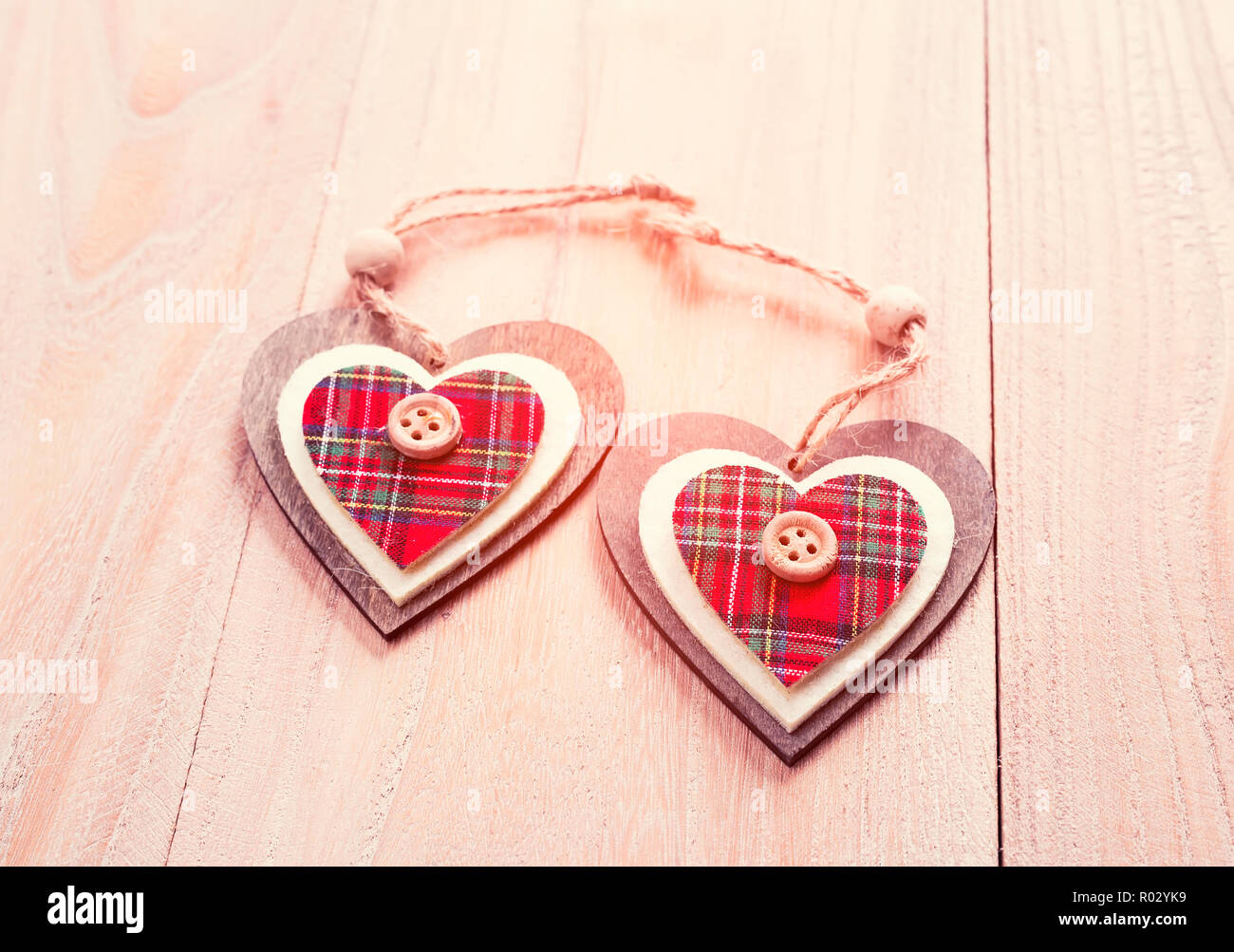 Christmas decoration red, white, gingham, stripes fabric stars and heart shape with buttons on rustic Elm wood background Stock Photo