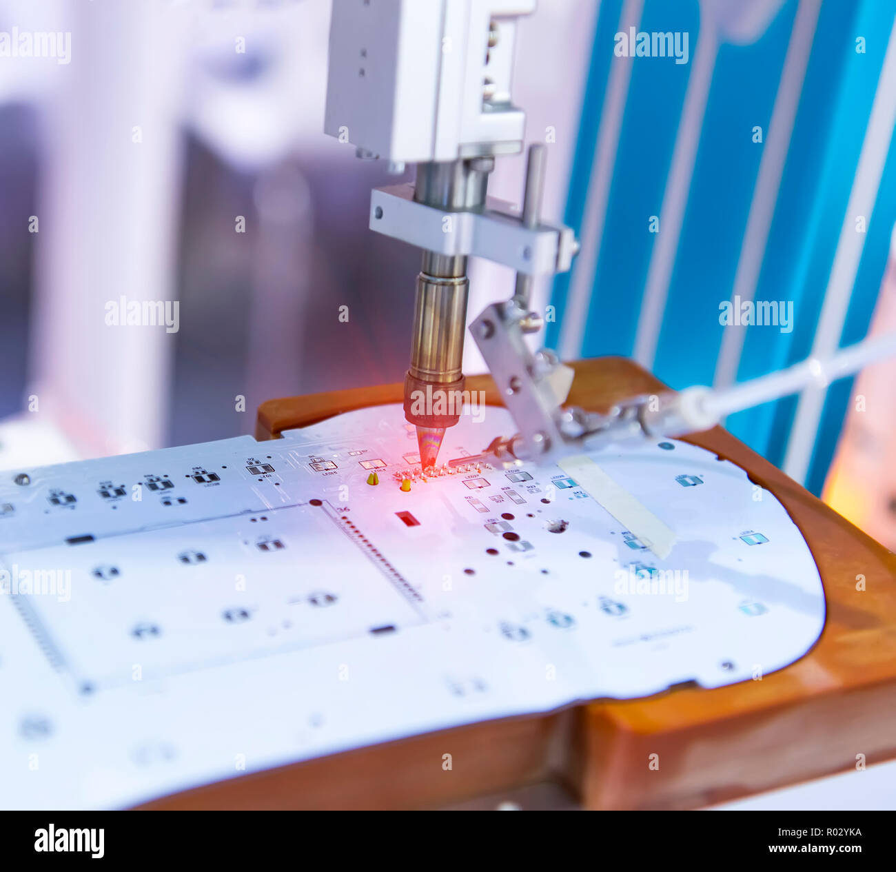 soldering iron tips of robotic system for automatic point soldering for printed and assembly electric circuit board ( PCB ) at factory Stock Photo