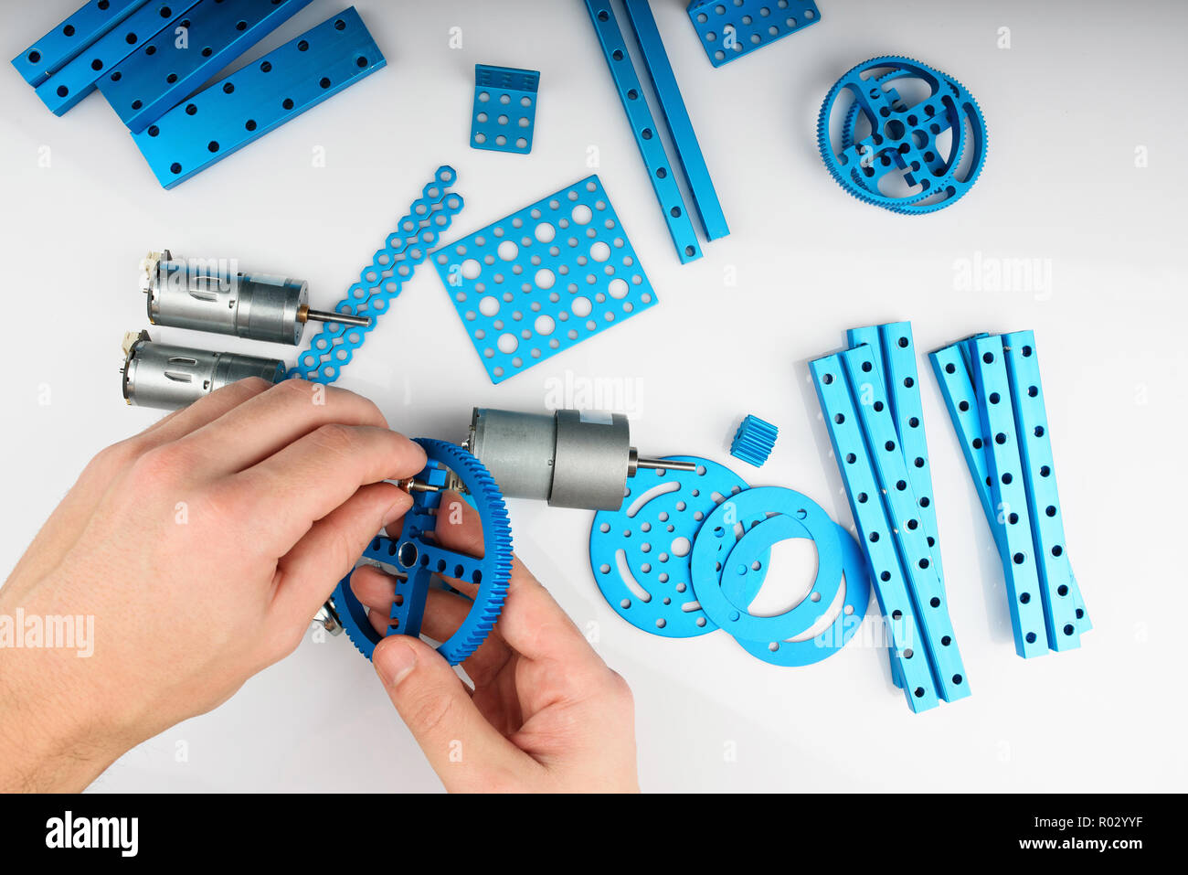 Man assembling metal robot kit. Above view of Making DIY set Stock Photo
