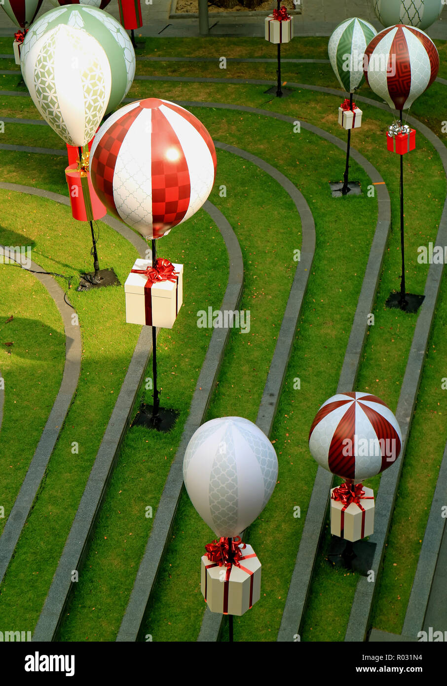 Outdoor Decoration Of The Festive Season With Square Shaped Gift Boxes Hanging On The Hot Air Balloons Over The Green Lawn Stock Photo Alamy