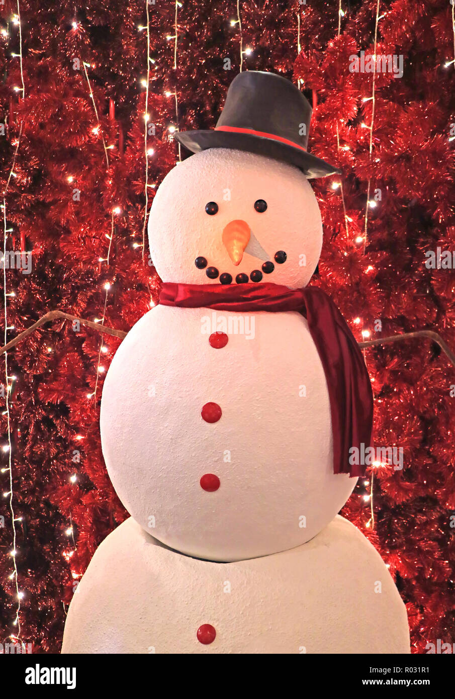 Vertical Photo Of A Big Snowman In Front Of Sparkling Artificial