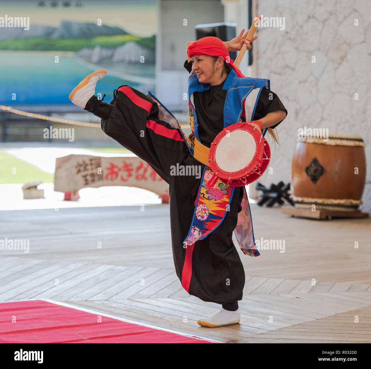 Okinawa / Japan - October 9, 2018: Eisa dancer steps up at Okinawa World folkloric dance performance. Stock Photo