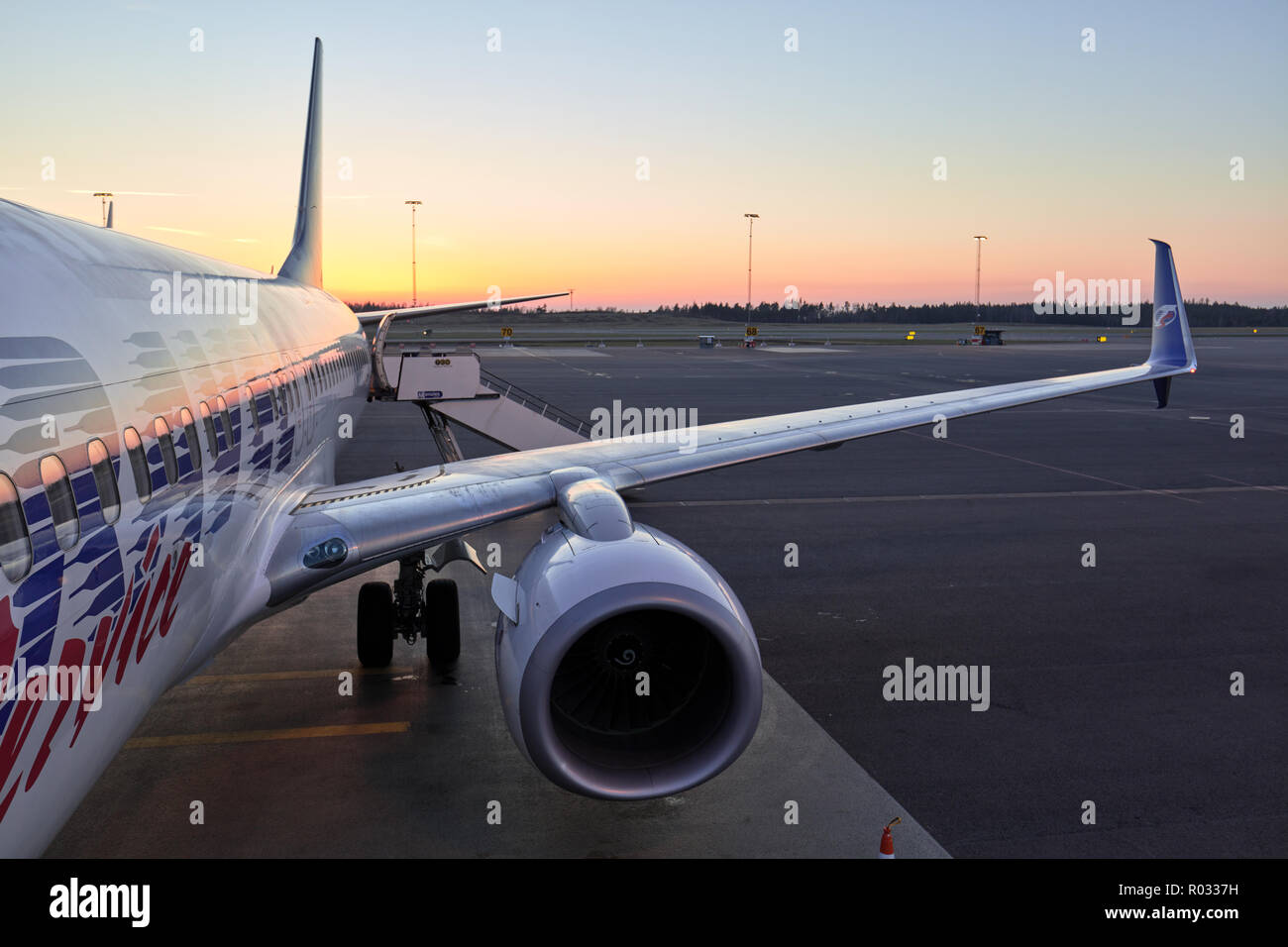 Jet airplane just having boarded passengers in a sunny evening in Arlanda Airport, Sweden Stock Photo