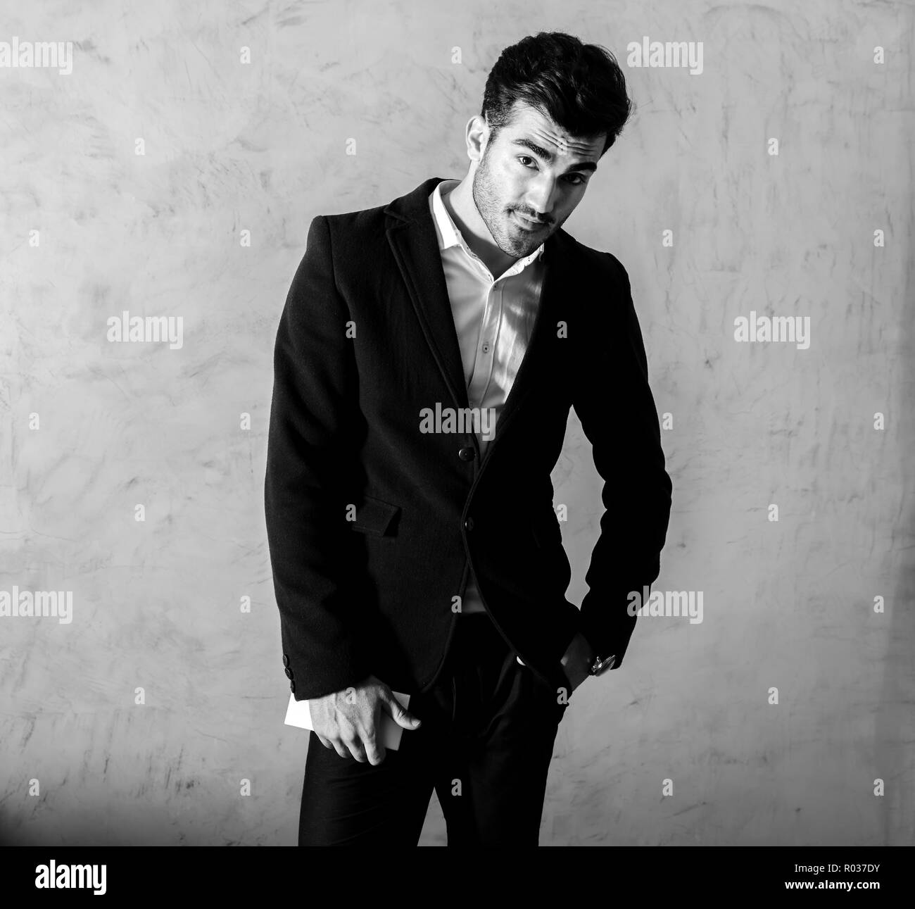 Young man in suit holding Black and White Stock Photos & Images - Alamy