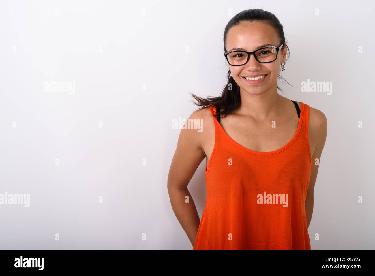 Studio shot of young happy Asian woman smiling while wearing eye Stock ...