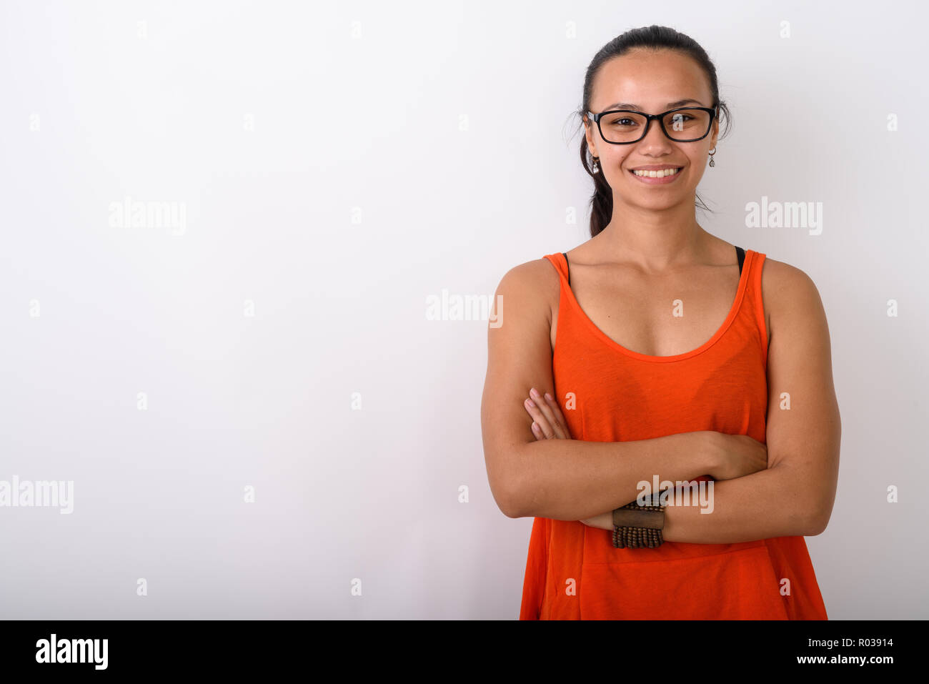 Studio shot of young happy Asian woman smiling while wearing eye Stock ...