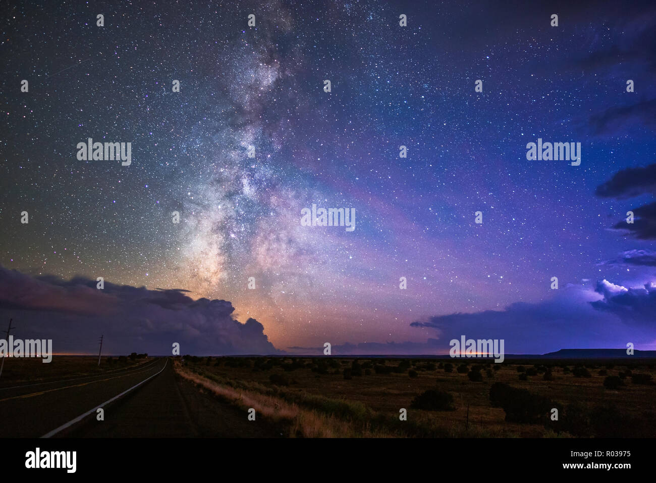 The Milky Way galaxy and stars with storms in the night sky near Winslow, Arizona Stock Photo