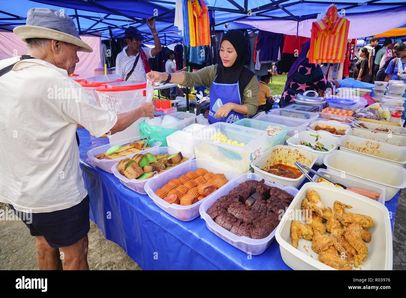 Tamparuli Sabah Malaysia - Aug 8, 2018 : Street food vendor selling cake at open market stall. Street eatery is popular among local and tourist. Stock Photo