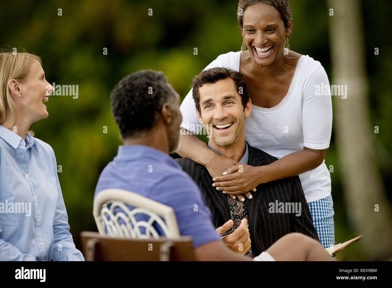 Small group of friends talking and laughing together Stock Photo Alamy