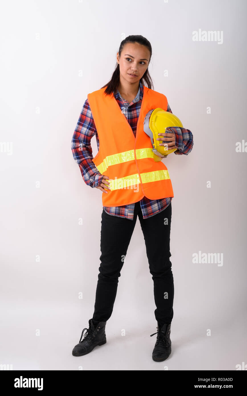 Full body shot of young Asian woman construction worker standing Stock Photo