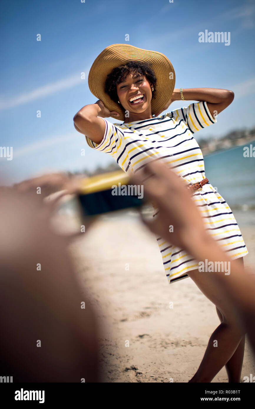 Couple taking pictures at beach. Stock Photo