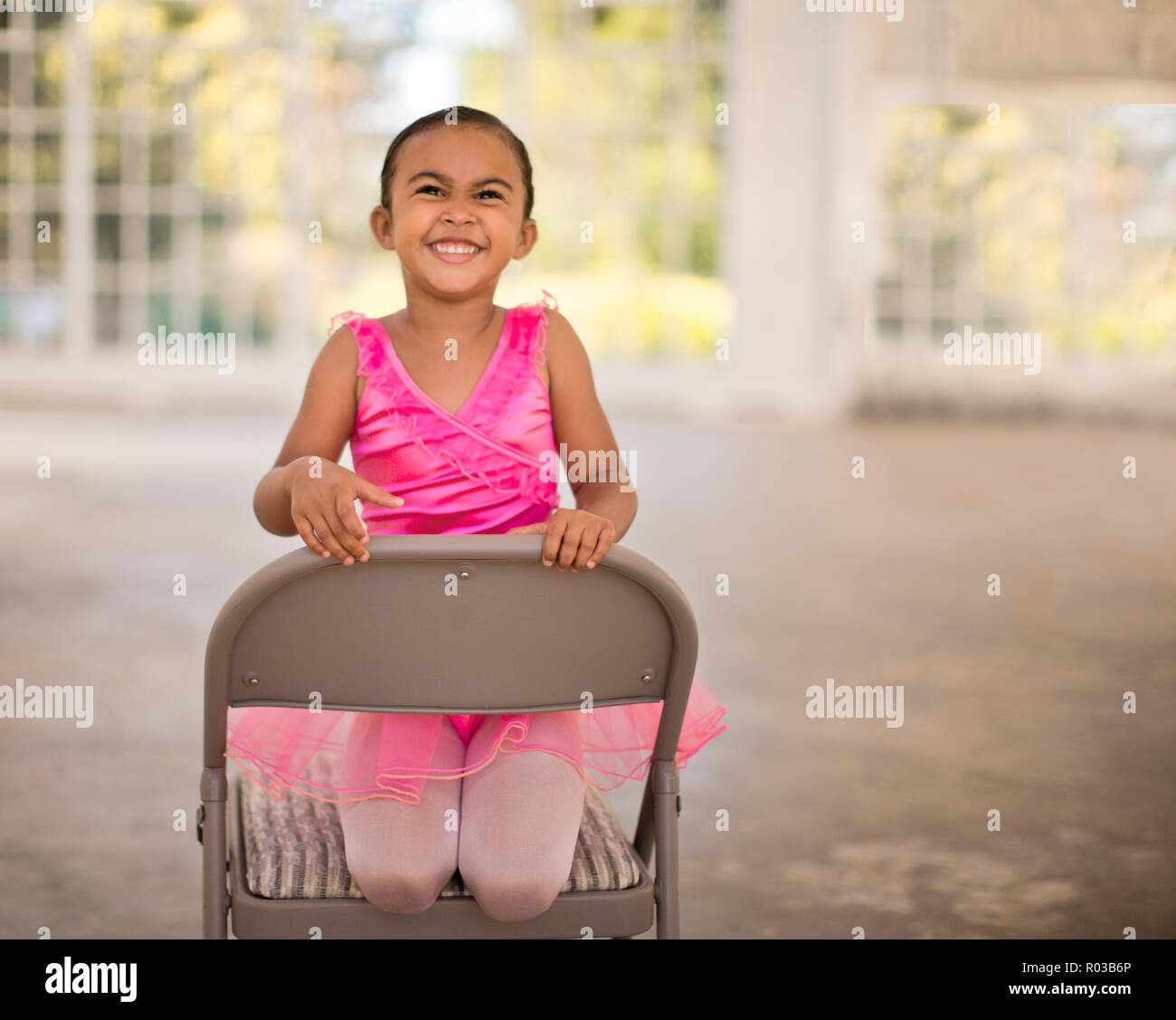 Girl kneeling on chair hi-res stock photography and images - Alamy