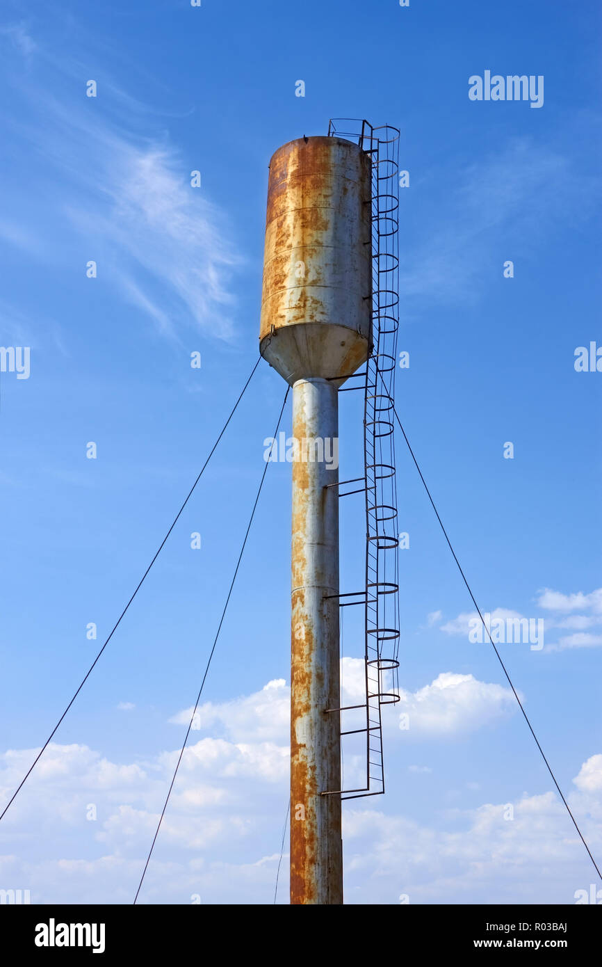 Large old metal water tower on the background of blue sky Stock Photo