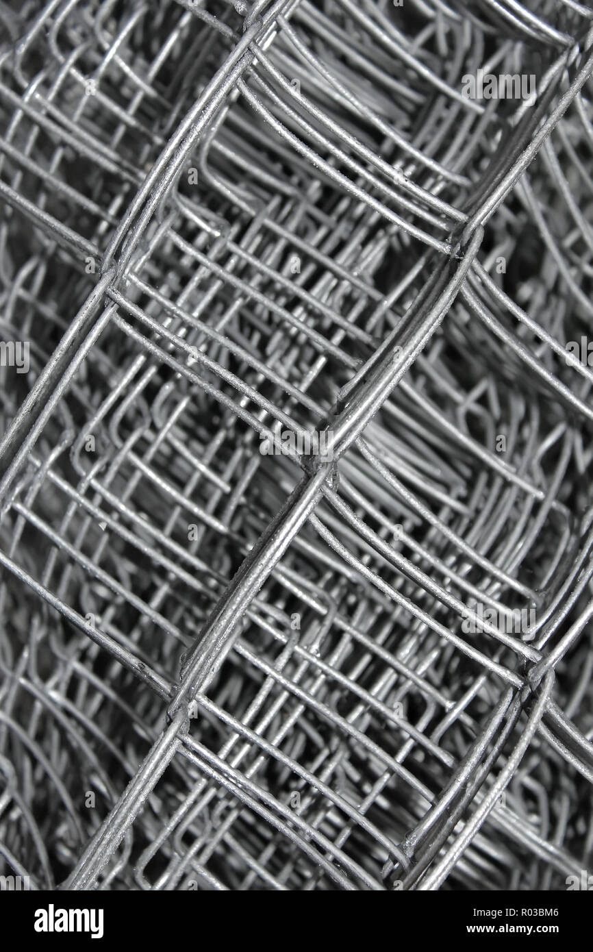 Steel mesh with water drops composed in multiple layers close-up Stock Photo