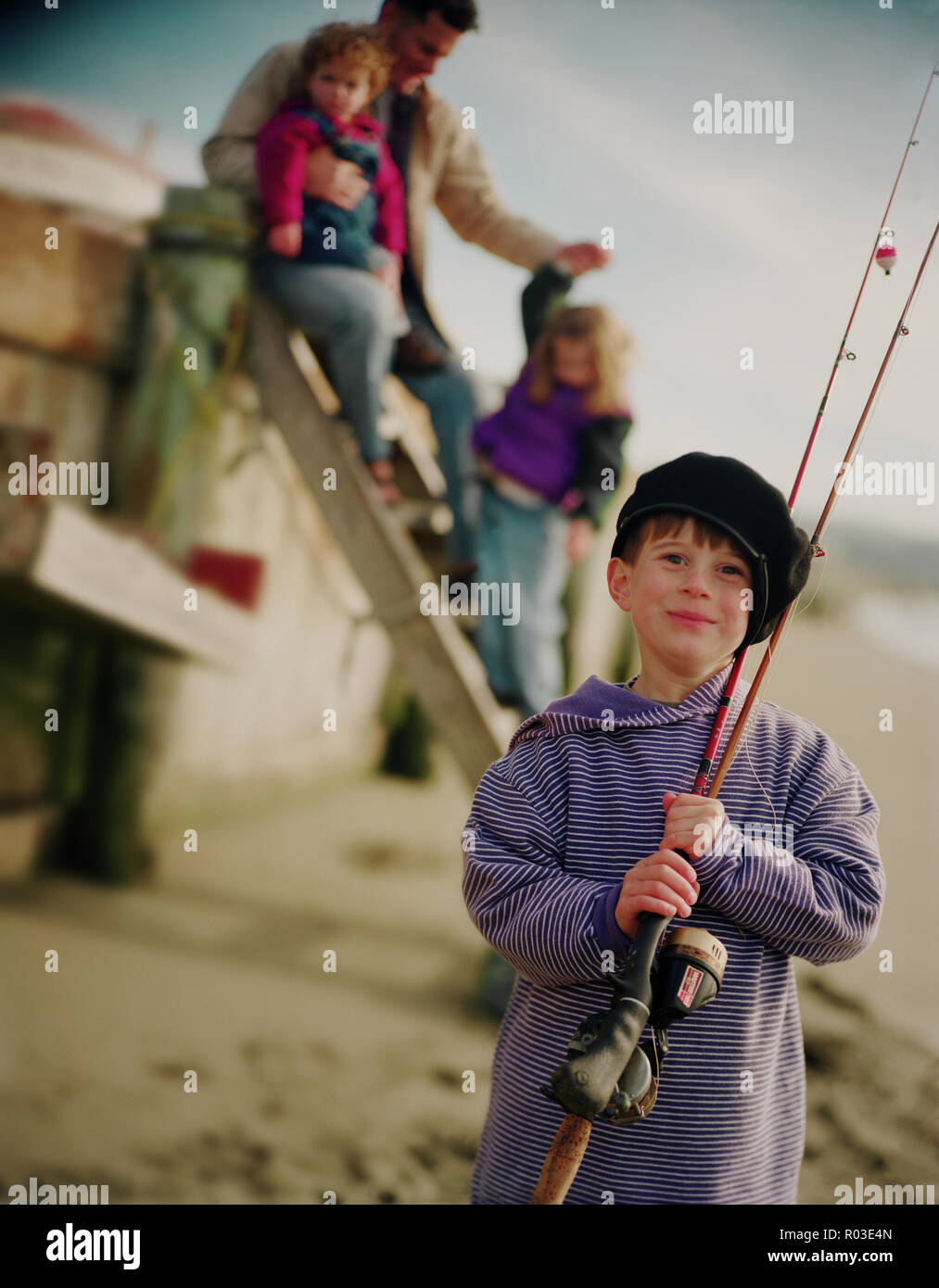 Boy holding a fishing pole hi-res stock photography and images - Alamy