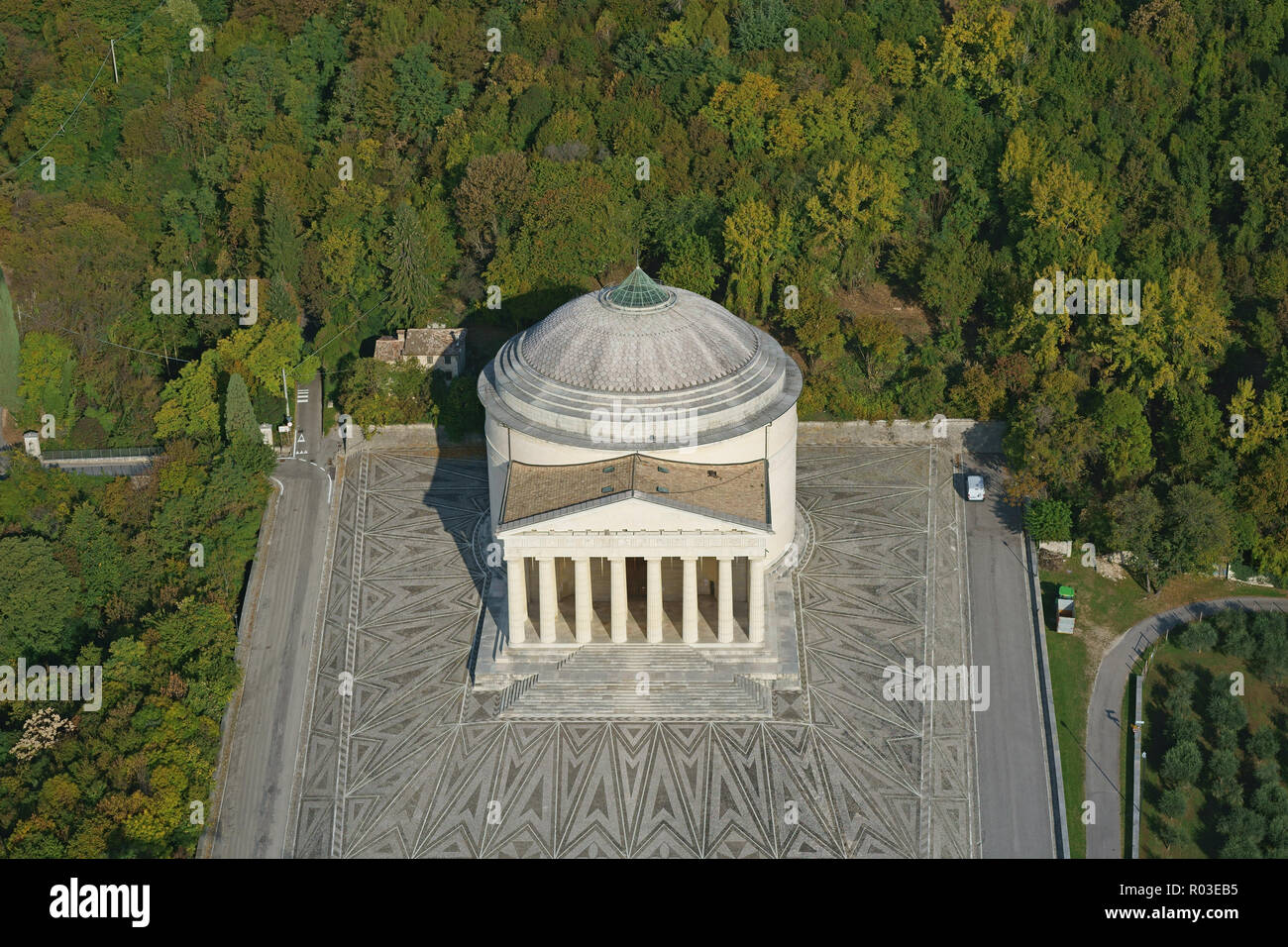 AERIAL VIEW. Temple of Canoviano with a background of trees with autumnal colors. Possagno, Province of Treviso, Veneto, Italy. Stock Photo