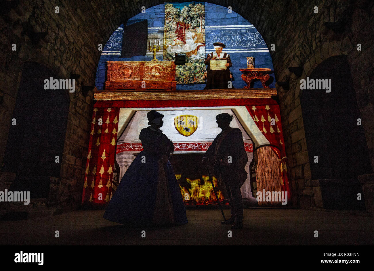 Clara Koenig and Colin Carr, from Living History Scotland, get into character at Craigmillar Castle on the outskirts of Edinburgh which is lit up with light projections and vivid recreations to form part of the Spotlight on Mary after-dark event which tells the story of the Craigmillar Bond; the plot by Mary Queen of Scots nobles to get rid of her husband, Darnley. Stock Photo