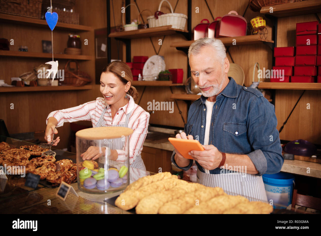Couple of successful businessman working hard in their own bakery Stock Photo