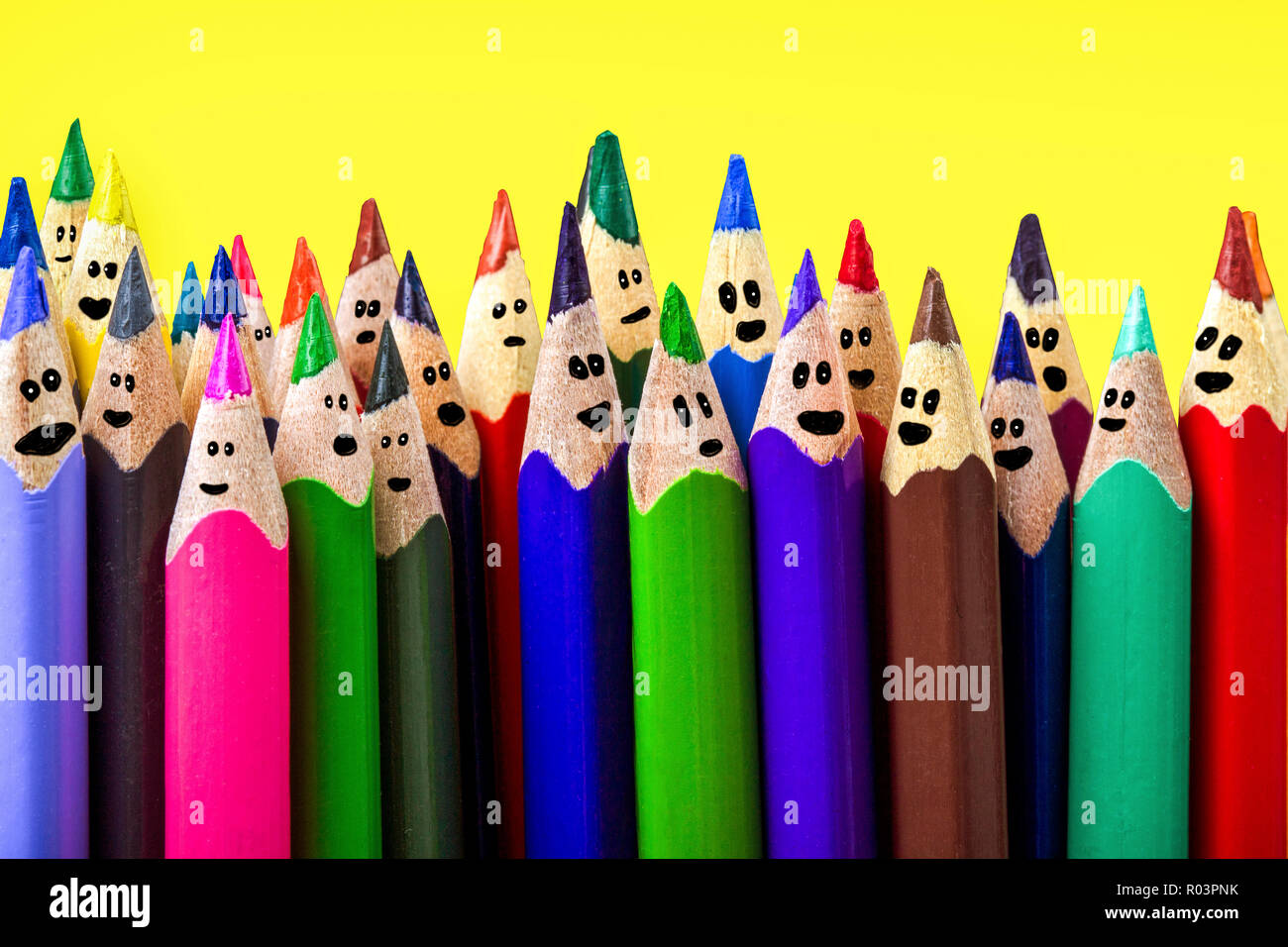 https://c8.alamy.com/comp/R03PNK/colored-pencils-with-drawn-cartoon-faces-on-an-yellow-background-a-holiday-concept-or-a-party-R03PNK.jpg