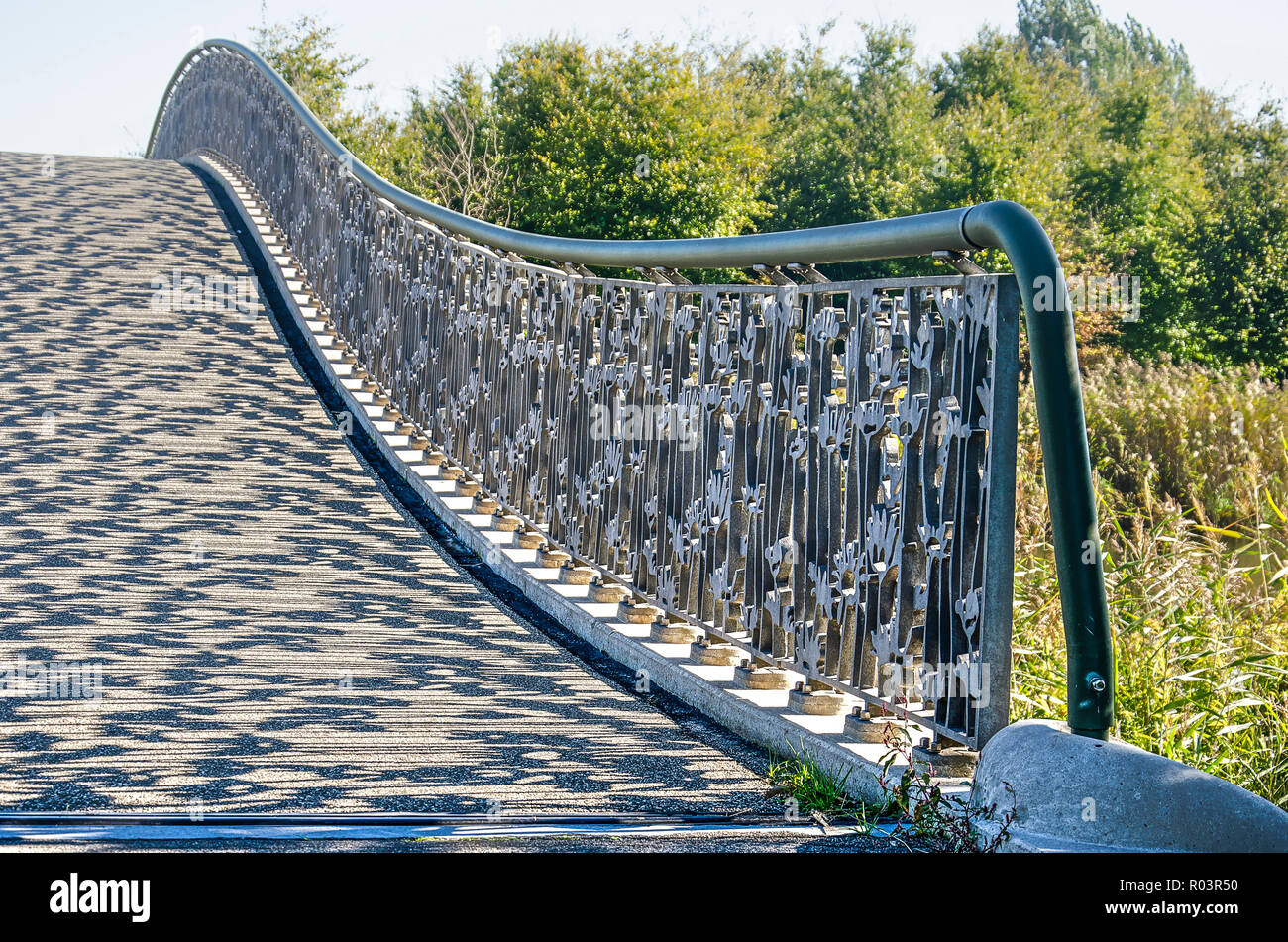 Utrecht, The Netherlands, September 27, 2018: detail of the arch bridge across Lelievijver (Lily Pond) in Maximapark, with the steel railing casting s Stock Photo