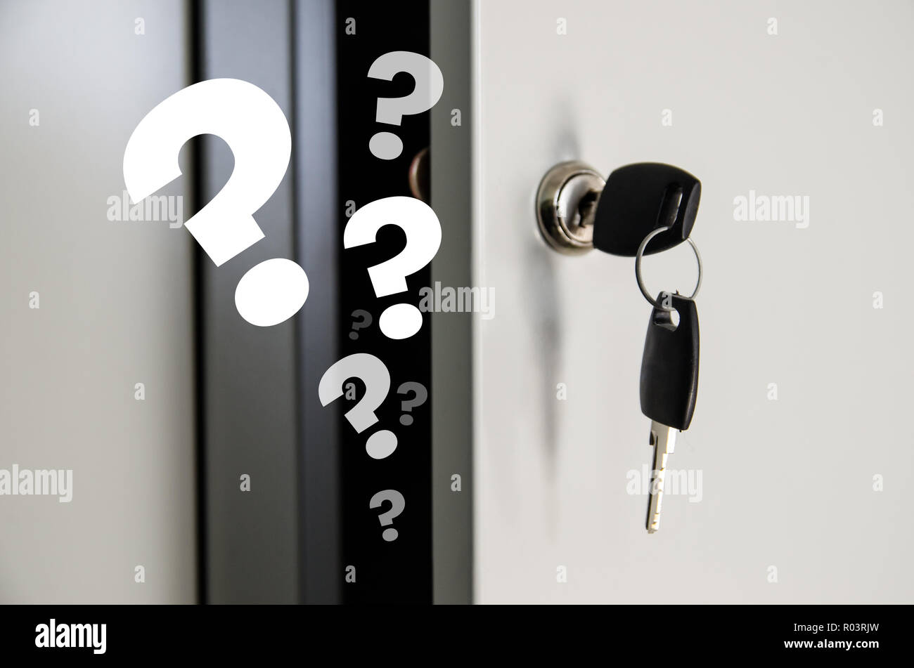 keys in the door of an open private locker where question marks fly out Stock Photo